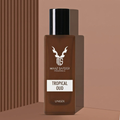 A brown rectangular fragrance bottle with a black cap and white printed label reading 'MAAZ SAFDER FRAGRANCE', 'TROPICAL OUD', and 'UNISEX', shown on a warm beige background with vertical brown stripes on the left.